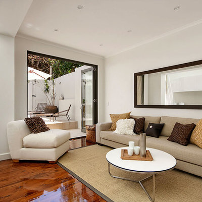Example of a trendy living room design in Sydney with white walls