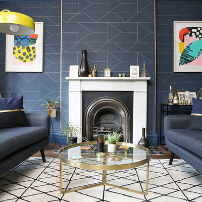 Trendy formal living room photo in London with blue walls and a standard fireplace