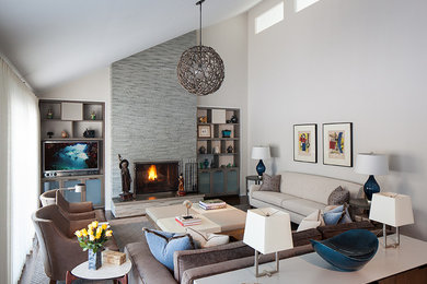 Inspiration for a large coastal open concept dark wood floor living room remodel in New York with beige walls, a standard fireplace, a stone fireplace and a media wall