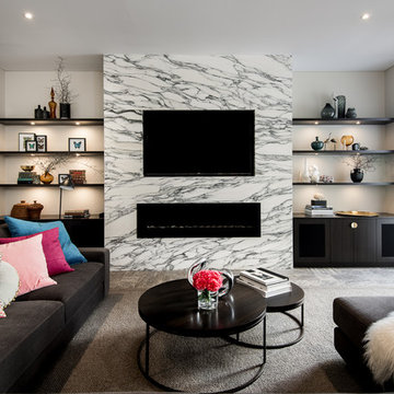 Contemporary living room with gas fireplace, custom cabinetry and Arabescato mar