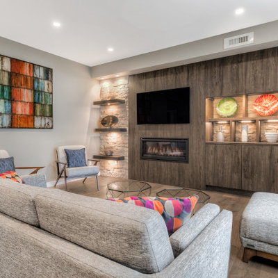 Living room - contemporary open concept dark wood floor and brown floor living room idea in Seattle with gray walls, a ribbon fireplace and a wall-mounted tv