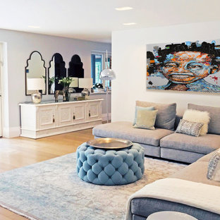 Design ideas for a large mediterranean formal open plan living room in London with white walls, medium hardwood flooring, beige floors and a built-in media unit.