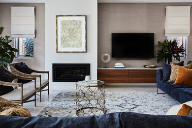 This is an example of a contemporary formal open plan living room in Sydney with beige walls, ceramic flooring, a standard fireplace, a plastered fireplace surround, a wall mounted tv and beige floors.