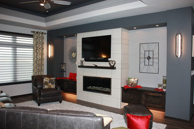 Inspiration for a mid-sized contemporary open concept vinyl floor living room remodel in Other with gray walls, a standard fireplace, a tile fireplace and a wall-mounted tv