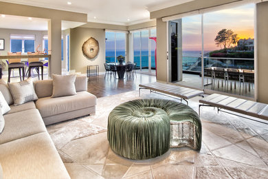 Huge trendy open concept living room photo in Orange County with beige walls