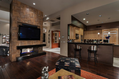 Inspiration for a large contemporary open concept dark wood floor living room remodel in Phoenix with multicolored walls, a two-sided fireplace, a tile fireplace and a wall-mounted tv