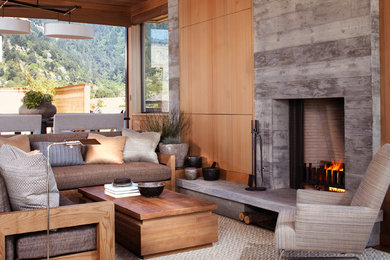 Inspiration for a small coastal open concept living room remodel in San Francisco with a standard fireplace and a concrete fireplace