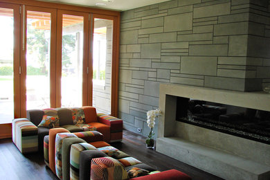 Trendy dark wood floor living room photo in Vancouver with gray walls, a ribbon fireplace and a concrete fireplace