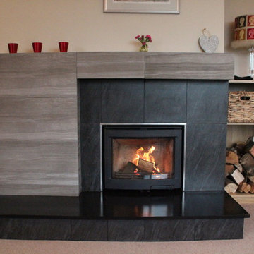 Contura i5 wood stove with honed slate hearth and porcelain tiled fireplace