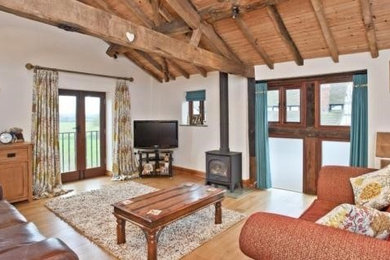This is an example of a farmhouse living room in West Midlands.
