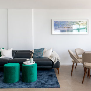 Design ideas for a beach style living room in Sydney with white walls and beige floor.