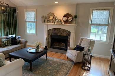 Example of a mid-sized transitional open concept light wood floor and multicolored floor living room design in Providence with beige walls, a standard fireplace, a stone fireplace and a media wall
