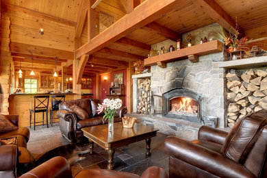 Living room - slate floor living room idea in Toronto with a wood stove and a stone fireplace