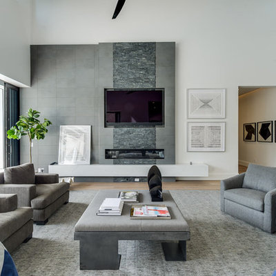 Inspiration for a contemporary open concept medium tone wood floor and brown floor living room remodel in Miami with white walls, a ribbon fireplace, a tile fireplace and a wall-mounted tv