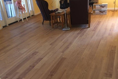 Mid-sized beach style enclosed vinyl floor living room photo in San Luis Obispo with yellow walls, a standard fireplace, a brick fireplace and a wall-mounted tv