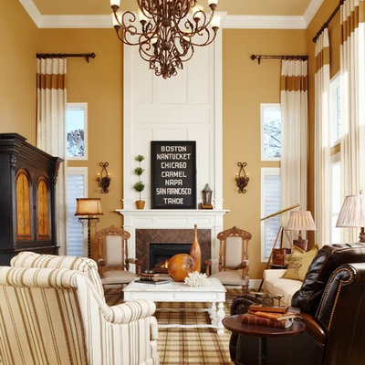 Example of a classic formal living room design in Detroit with yellow walls and a standard fireplace