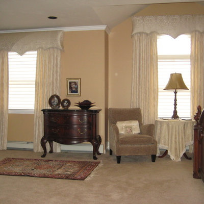 Example of a small classic open concept medium tone wood floor and brown floor living room design in New York with a music area, pink walls, no fireplace and no tv