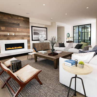Inspiration for a contemporary formal and open concept medium tone wood floor living room remodel in Los Angeles with white walls and a ribbon fireplace