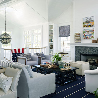 Example of a large beach style open concept light wood floor living room design in San Diego with white walls, a standard fireplace and a stone fireplace