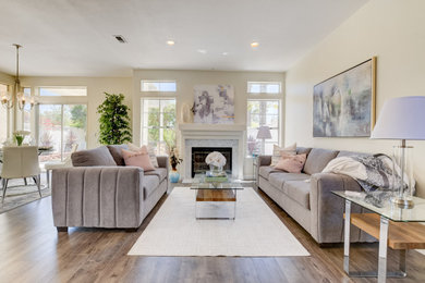 Living room - large contemporary formal and open concept medium tone wood floor and brown floor living room idea in San Diego with beige walls, a standard fireplace, a tile fireplace and no tv
