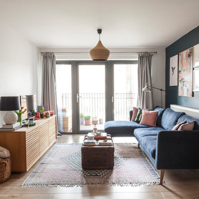 Inspiration for an eclectic brown floor living room remodel in London with blue walls and a tv stand