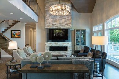 Inspiration for a large transitional open concept medium tone wood floor living room remodel in Other with beige walls, a ribbon fireplace, a stone fireplace and a wall-mounted tv