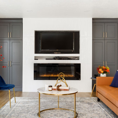 Example of a mid-sized trendy open concept laminate floor and beige floor living room design in Salt Lake City with white walls, a standard fireplace, a tile fireplace and a wall-mounted tv