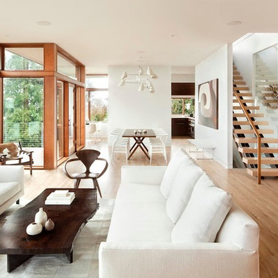 Inspiration for a modern open concept light wood floor living room remodel in Portland with white walls