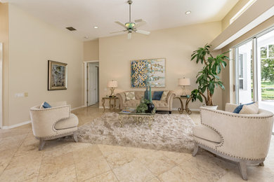 Living room - large mediterranean formal and open concept travertine floor and beige floor living room idea in Tampa with beige walls