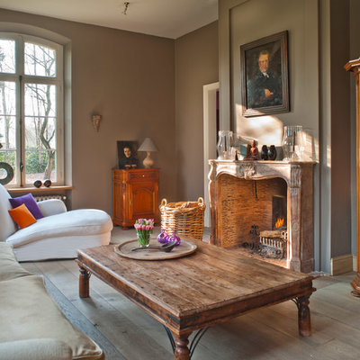Elegant living room photo in Other with gray walls and a standard fireplace