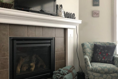 Example of a small 1950s formal and open concept dark wood floor and brown floor living room design in Edmonton with beige walls, a standard fireplace, a tile fireplace and a tv stand