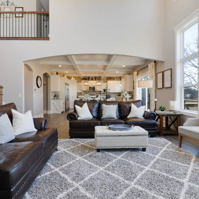 Living room - large farmhouse formal and open concept medium tone wood floor and brown floor living room idea in Grand Rapids with gray walls, a standard fireplace, a stone fireplace and a wall-mounted tv