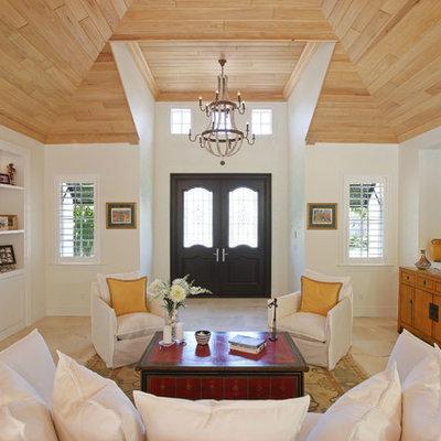 Large island style formal and open concept travertine floor living room photo in Miami with white walls, no fireplace and no tv