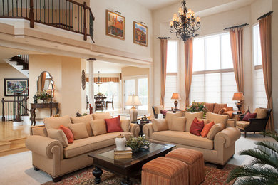 Photo of a large mediterranean open plan living room in Chicago with beige walls, carpet, a standard fireplace and a plastered fireplace surround.