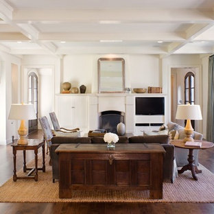 Inspiration for a transitional dark wood floor and brown floor living room remodel in Austin with white walls, a standard fireplace and a media wall