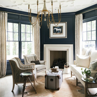 Example of a large transitional formal and enclosed light wood floor and beige floor living room design in Atlanta with blue walls, a standard fireplace, a plaster fireplace and no tv