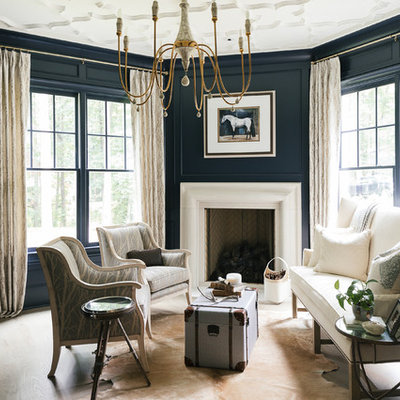 Example of a large transitional formal and enclosed light wood floor and beige floor living room design in Atlanta with blue walls, a standard fireplace, a plaster fireplace and no tv