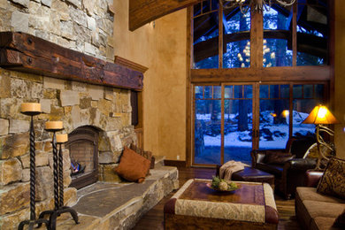 Example of a large classic open concept and formal dark wood floor and brown floor living room design in Other with beige walls, a standard fireplace, a stone fireplace and no tv