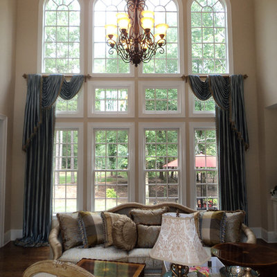 Example of a mid-sized classic formal and open concept medium tone wood floor living room design in Charlotte with no fireplace, no tv and beige walls