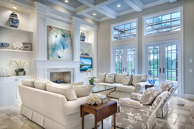Inspiration for a timeless open concept travertine floor living room remodel in Tampa with a standard fireplace, a wood fireplace surround and a media wall