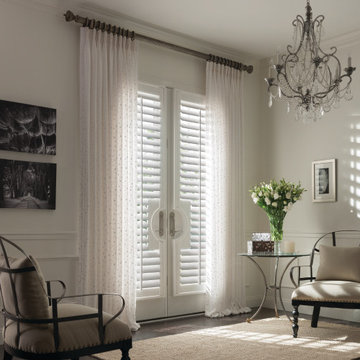 Custom shutters for french doors layered with sheer drapery panels