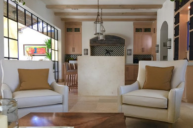 Example of a mid-sized tuscan formal and open concept travertine floor and brown floor living room design in Houston with beige walls, no fireplace and no tv