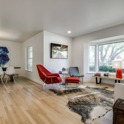 Example of a mid-sized danish formal and open concept light wood floor living room design in Dallas with white walls, no fireplace and no tv