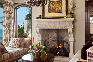 Inspiration for a mid-sized mediterranean formal and open concept living room remodel in Orange County with beige walls, a standard fireplace and a stone fireplace