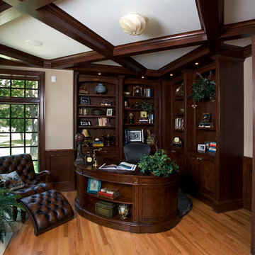Dark stained cherry library with built-in bookcases and coffer ceiling