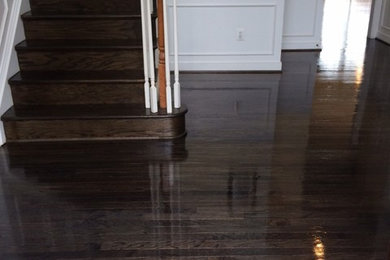 Arts and crafts medium tone wood floor and brown floor living room photo in Baltimore with white walls