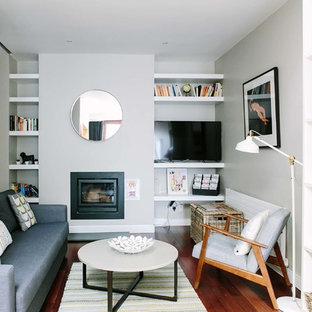 Living room - small scandinavian enclosed dark wood floor living room idea in Dublin with white walls, a wood stove, a metal fireplace and a tv stand