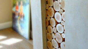 Decorative Logs Stacked in an Alcove of a Large Open Fireplace - Wooden Mantel