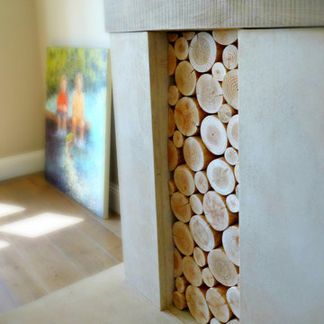 Decorative Logs Stacked in an Alcove of a Large Open Fireplace - Wooden Mantel