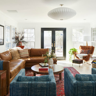 Inspiration for a transitional light wood floor and beige floor living room remodel in Austin with white walls, a brick fireplace, a standard fireplace and a wall-mounted tv